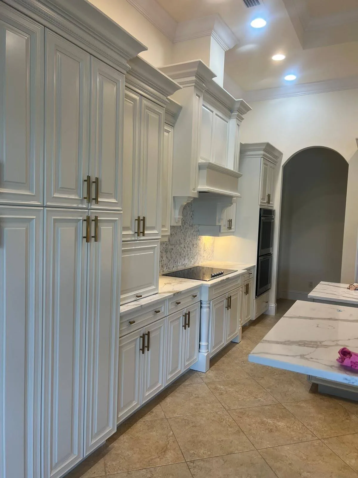 Refinished white cabinets either side of the range