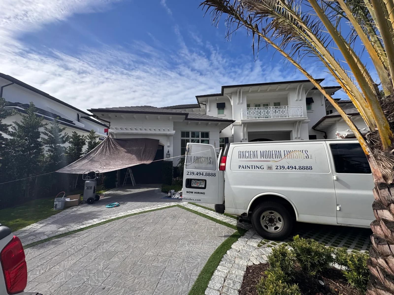 Company van parked outside a Naples home mid-project