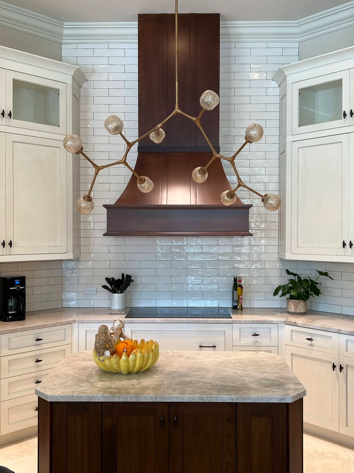 Kitchen with a hand-finished copper range hood