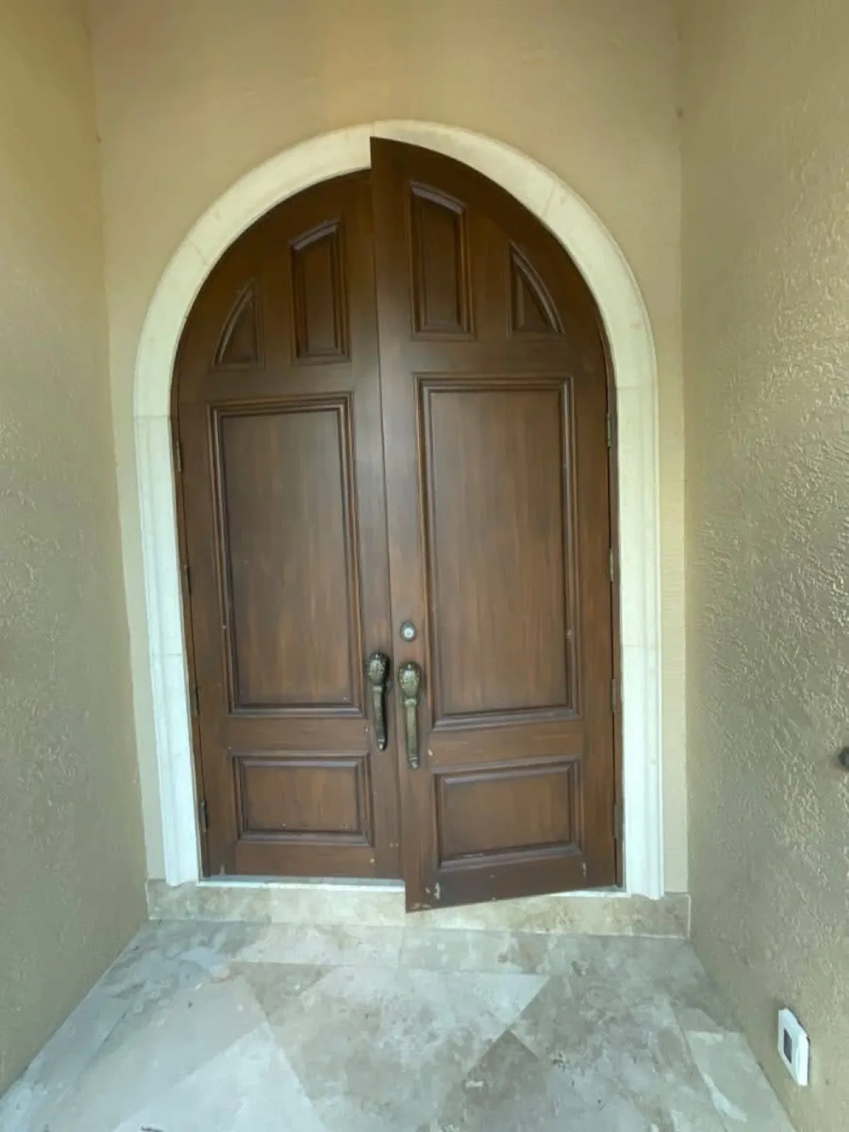 Entry door with a faded, weathered finish before restoration