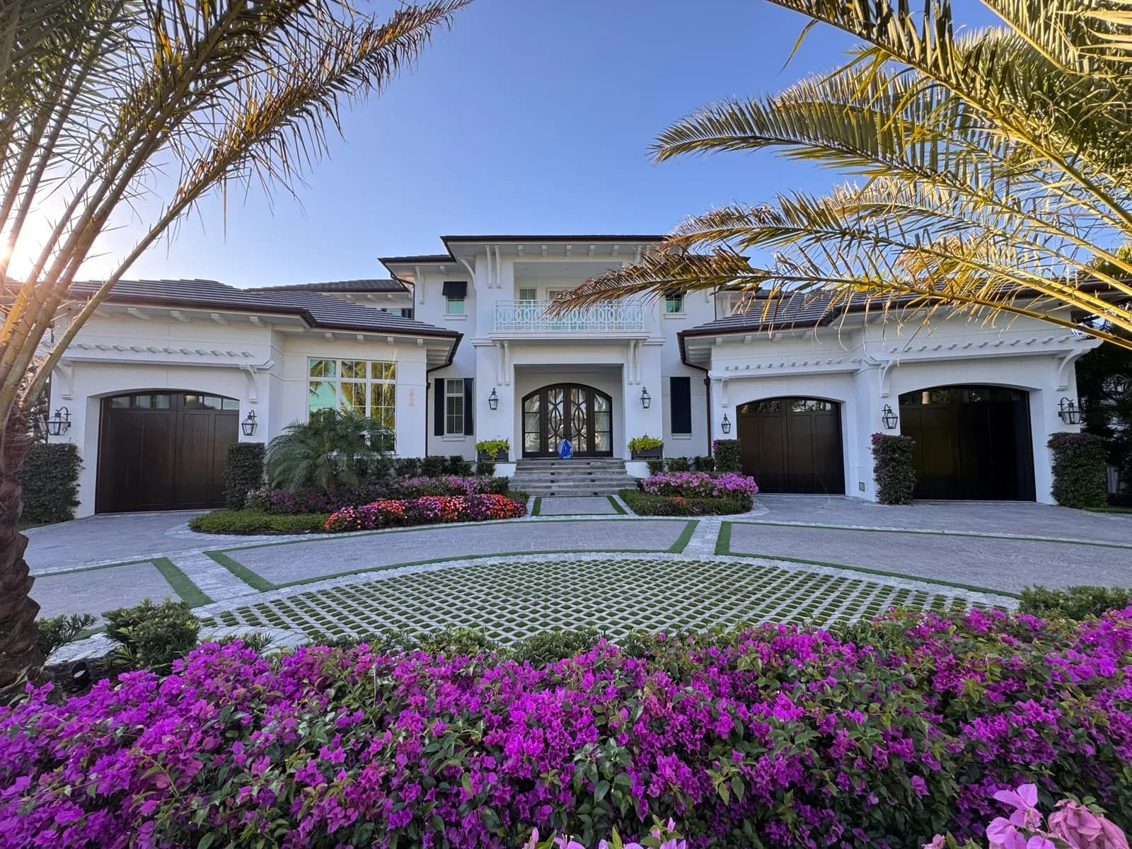 Front elevation with refinished garage doors and bougainvillea
