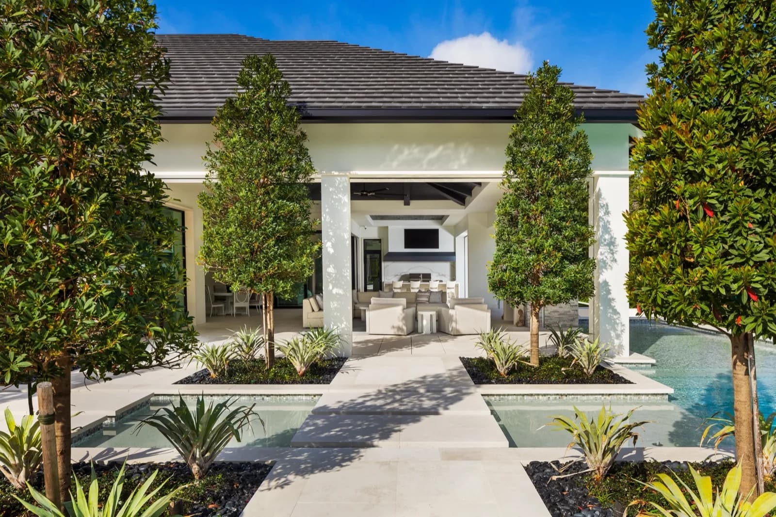 Courtyard entry with painted columns and a reflecting pool