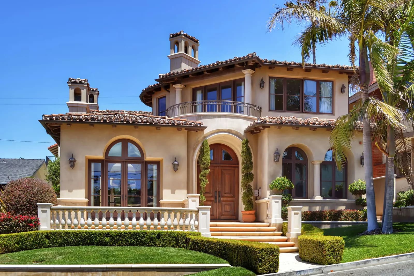 Mediterranean villa with painted stucco, stone columns and a tile roof