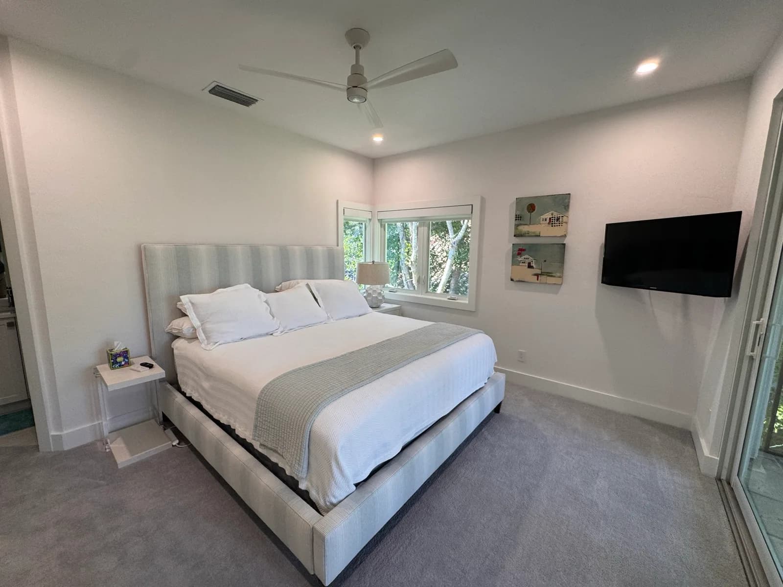 Bedroom with a grey headboard and crisp white trim