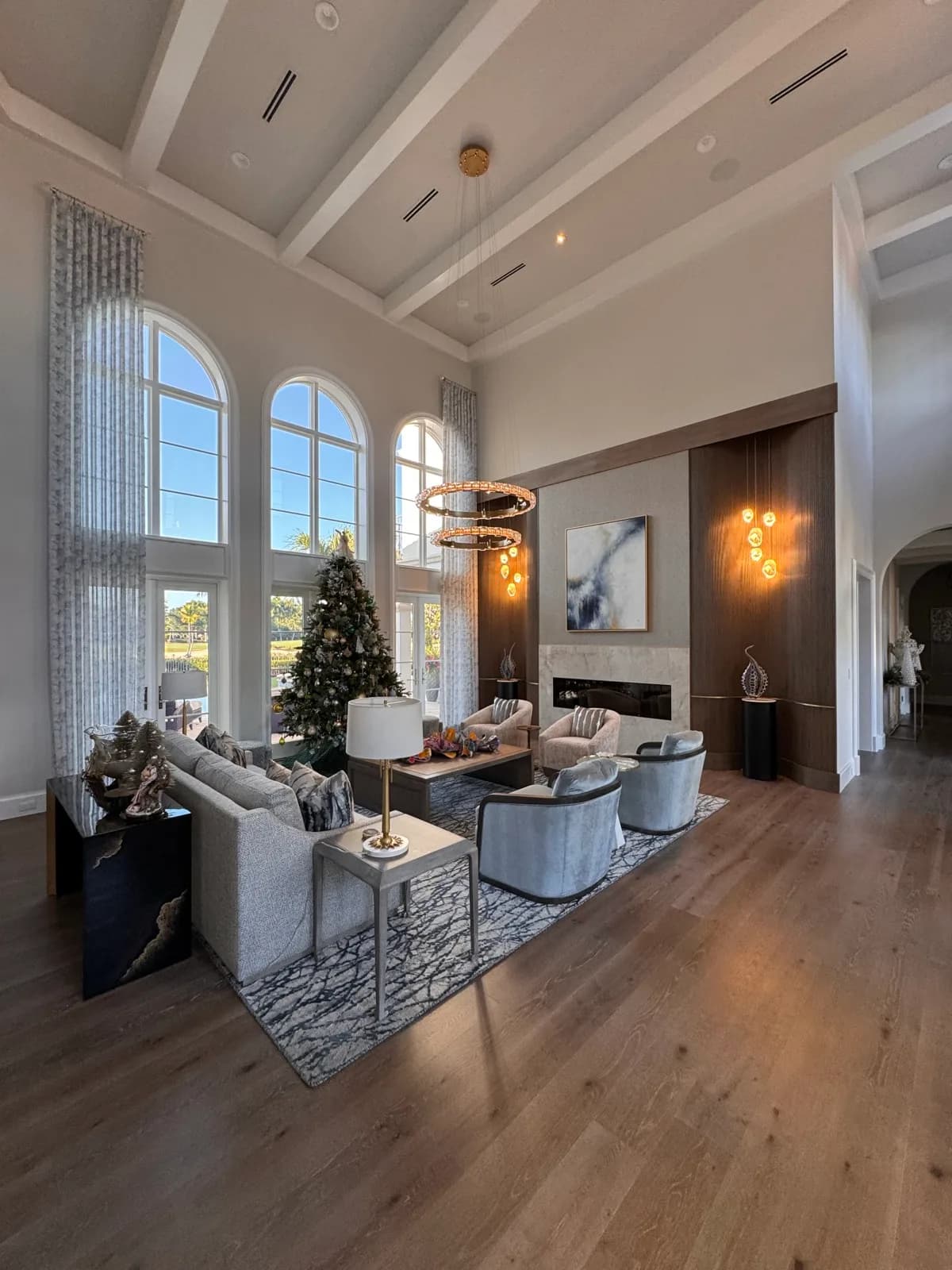 Great room with two-storey windows and a fireplace wall