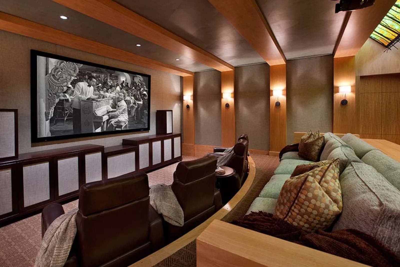 Home theatre with sconce lighting and a painted ceiling